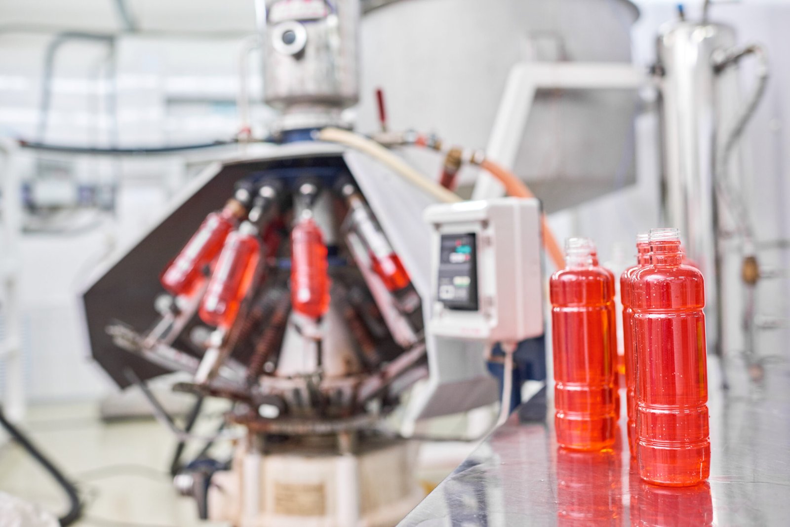 Close-up open plastic bottles full of ready product at sports nutrition production.