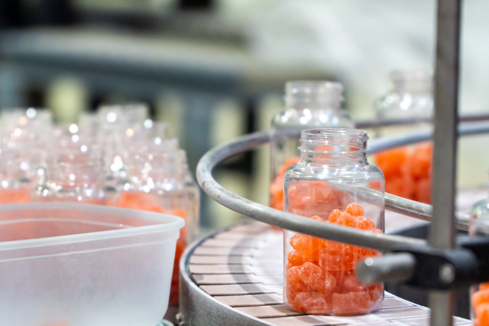 Nutritional supplement jars on the packaging process on a confectionery factory facility Nutritional supplement jars on the packaging process on a confectionery factory facility